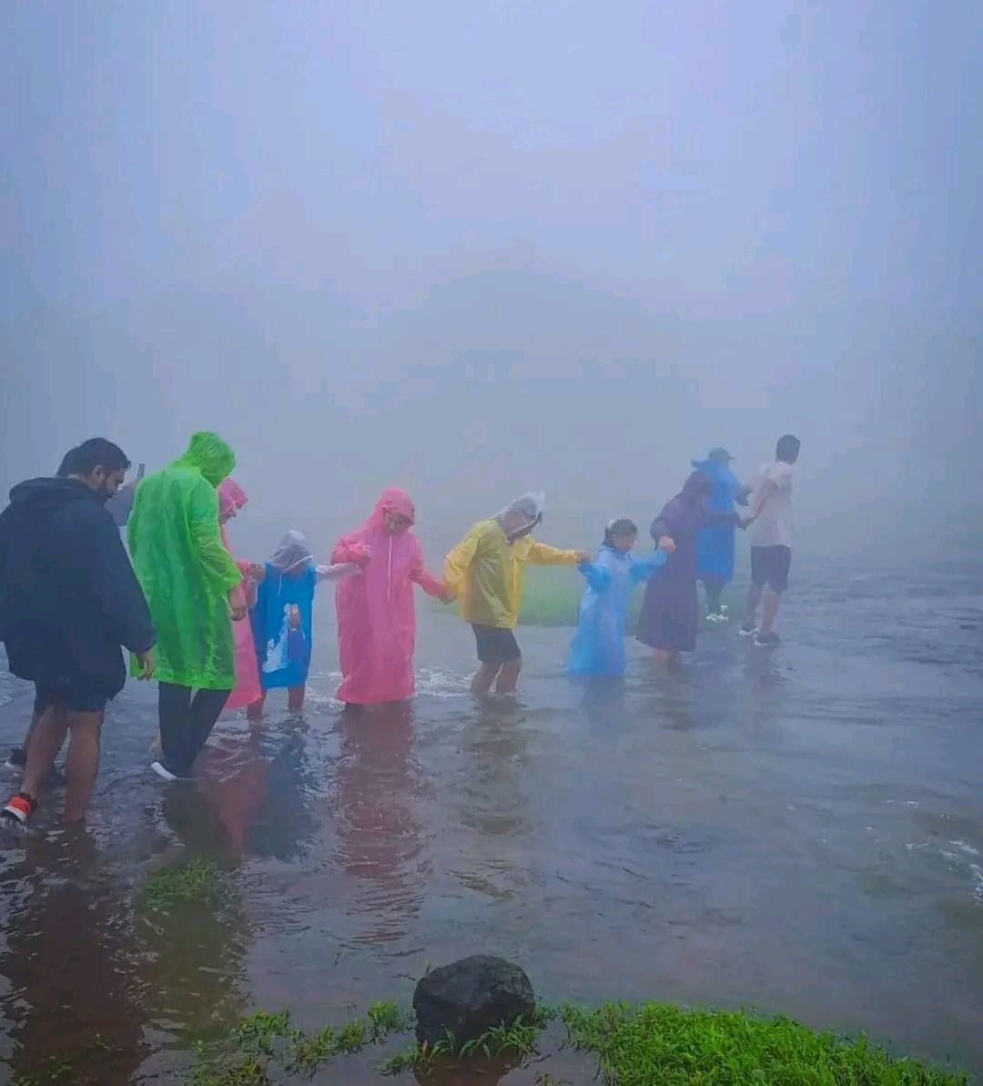 Family enjoying misty Bhandardara waterfall